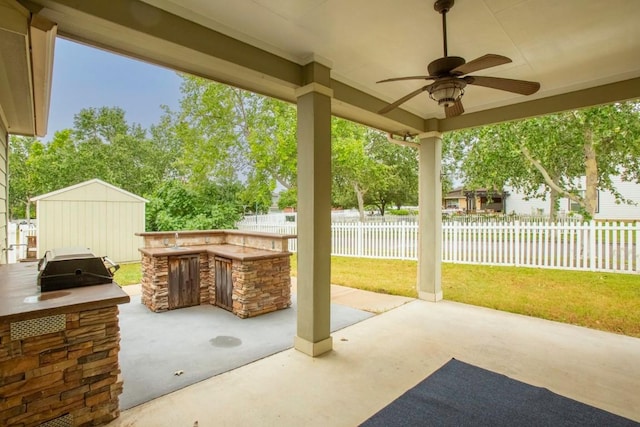 221 Mcgarity St, Kyle, TX 78640 - view of patio with ceiling fan, an outdoor kitchen, and an outdoor structure