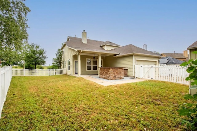 221 Mcgarity St, Kyle, TX 78640 - back of house with a garage, ceiling fan, a chimney, and a patio