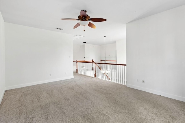 221 Mcgarity St, Kyle, TX 78640 - spare room featuring attic access, a ceiling fan, carpet, and baseboards