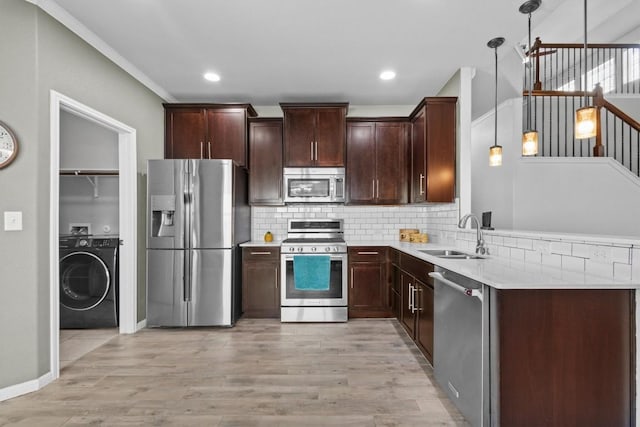 1913 Gabrielles Way, Manchaca, TX 78652 - kitchen featuring stainless steel appliances, washer / dryer, a sink, tasteful backsplash, and light countertops