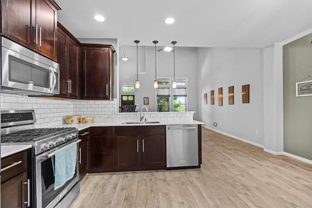 1913 Gabrielles Way, Manchaca, TX 78652 - kitchen featuring stainless steel appliances, a sink, light countertops, a peninsula, and decorative backsplash