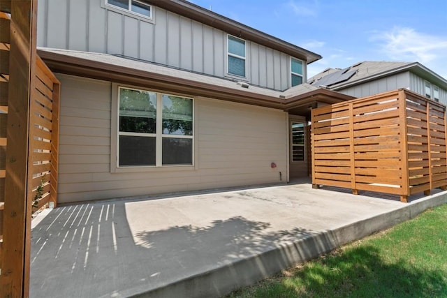 1913 Gabrielles Way, Manchaca, TX 78652 - view of front of home with board and batten siding and a patio area