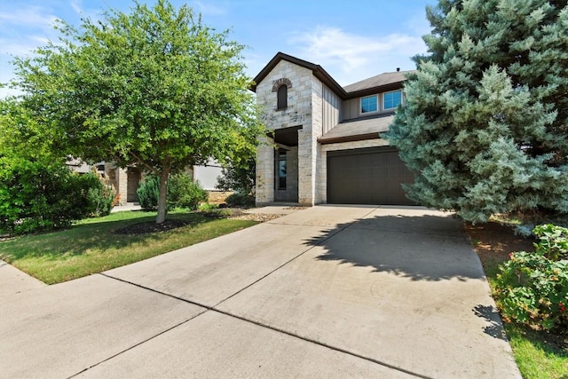 1913 Gabrielles Way, Manchaca, TX 78652 - view of front of house featuring stone siding, driveway, and a garage