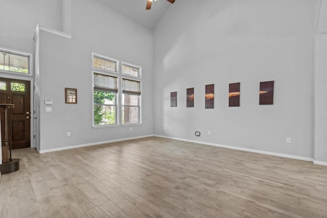 1913 Gabrielles Way, Manchaca, TX 78652 - unfurnished living room with a ceiling fan, high vaulted ceiling, healthy amount of natural light, and light wood-type flooring