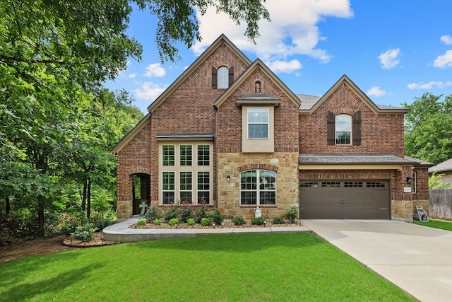 2337 Centennial Loop, Round Rock, TX 78665 - view of front facade featuring an attached garage, driveway, stone siding, and brick siding