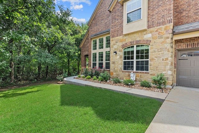 2337 Centennial Loop, Round Rock, TX 78665 - view of side of home featuring stone siding, a yard, brick siding, and a garage