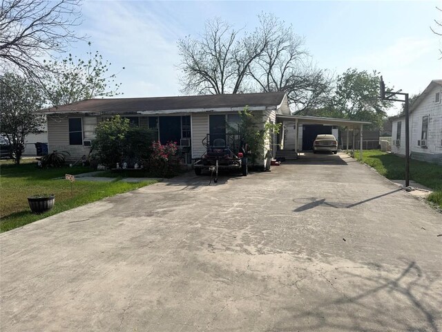 137 N Kowald Ln, New Braunfels, TX 78130 - view of front of home with concrete driveway, an attached carport, and a front yard