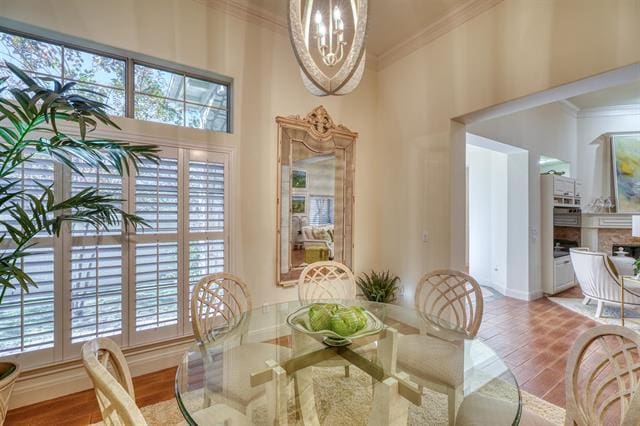 104 Mason Ct, Horseshoe Bay, TX 78657 - dining space with ornamental molding, plenty of natural light, and a chandelier