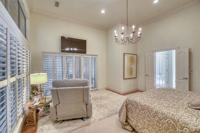 104 Mason Ct, Horseshoe Bay, TX 78657 - bedroom featuring a chandelier, ornamental molding, baseboards, a towering ceiling, and recessed lighting