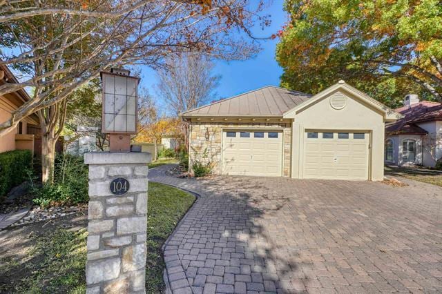 104 Mason Ct, Horseshoe Bay, TX 78657 - ranch-style home with decorative driveway, a garage, a standing seam roof, and metal roof