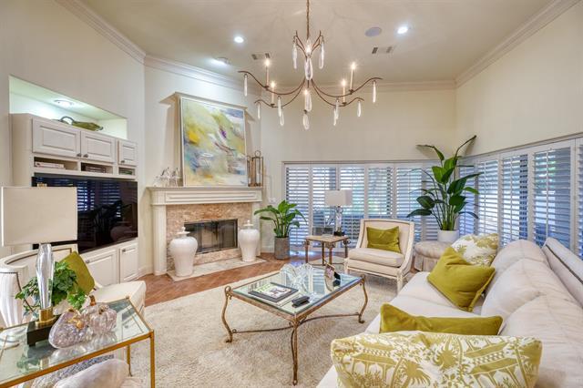 104 Mason Ct, Horseshoe Bay, TX 78657 - living area featuring ornamental molding, a chandelier, and a fireplace