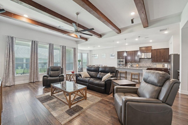 3113 Capra Cv, Round Rock, TX 78665 - living area featuring a ceiling fan, baseboards, recessed lighting, dark wood-style flooring, and beam ceiling