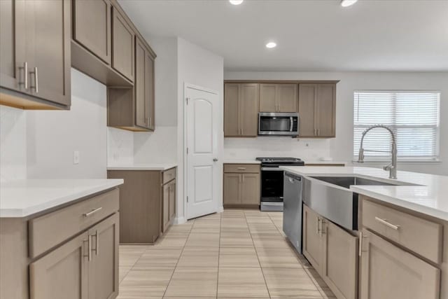 308 Castlefields St, Hutto, TX 78634 - kitchen featuring stainless steel appliances, recessed lighting, tasteful backsplash, light countertops, and light tile patterned flooring