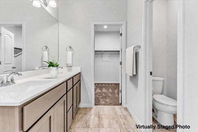 308 Castlefields St, Hutto, TX 78634 - bathroom featuring double vanity and a walk in closet