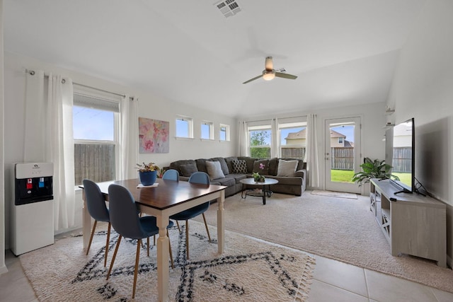 311 Spiny Lizard Ln, San Marcos, TX 78666 - dining area with healthy amount of natural light, a ceiling fan, vaulted ceiling, light tile patterned floors, and light colored carpet