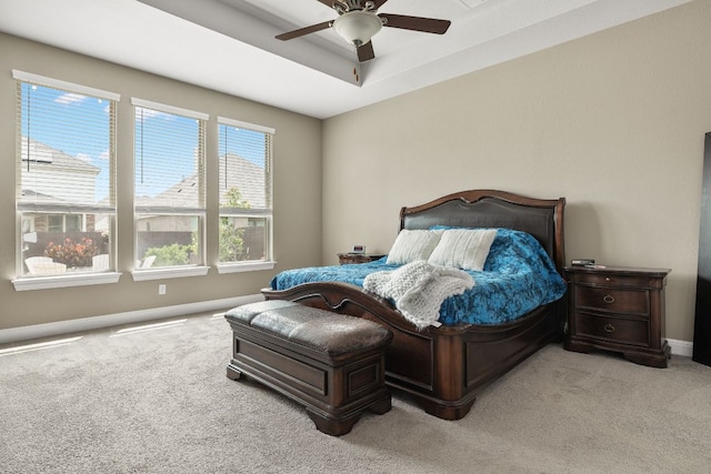 19325 Tristan Stone Dr, Pflugerville, TX 78660 - bedroom with light colored carpet, a ceiling fan, and a tray ceiling