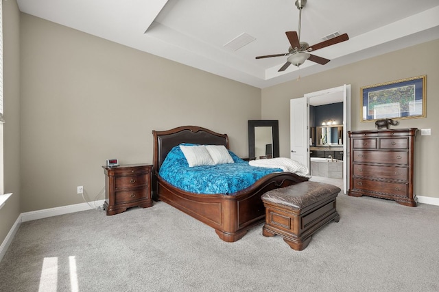 19325 Tristan Stone Dr, Pflugerville, TX 78660 - bedroom featuring carpet, a tray ceiling, connected bathroom, and ceiling fan