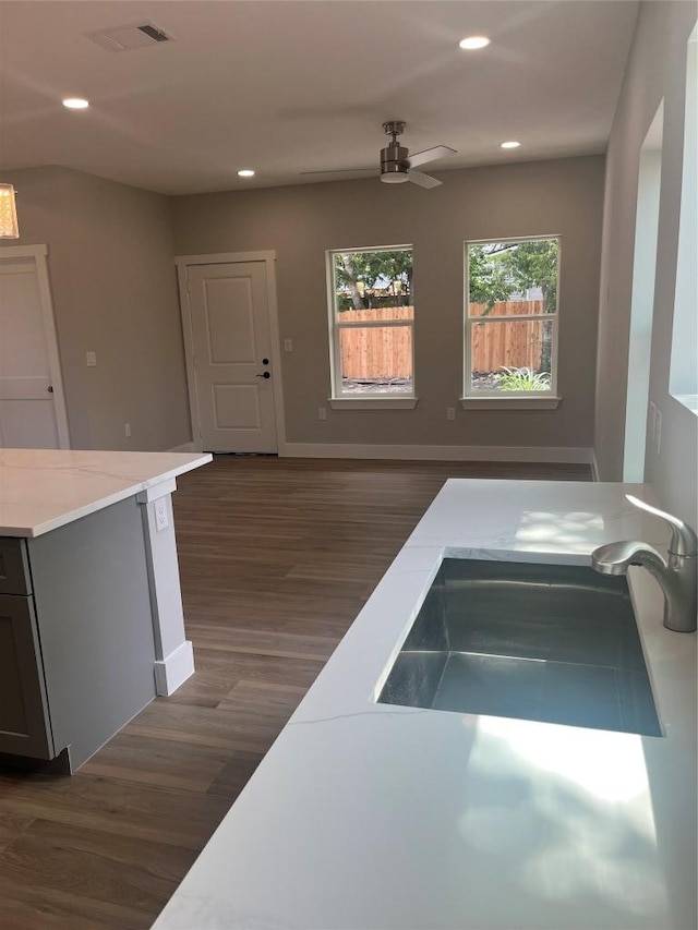 401 E Carrie St, Manor, TX 78653 - kitchen featuring dark wood-style floors, ceiling fan, recessed lighting, light countertops, and gray cabinetry