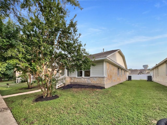 18132 Great Basin Ave, Pflugerville, TX 78660 - view of side of home with stone siding and a central AC unit