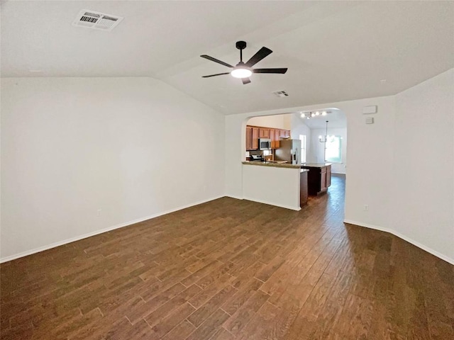 18132 Great Basin Ave, Pflugerville, TX 78660 - unfurnished living room with dark wood-style flooring, ceiling fan, vaulted ceiling, and arched walkways