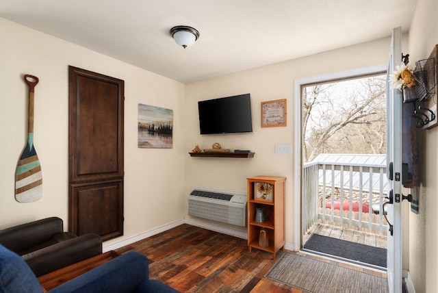 235 El Camino River Rd, Bastrop, TX 78602 - living area with dark wood finished floors and an AC wall unit