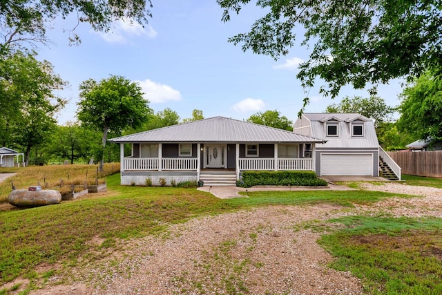 235 El Camino River Rd, Bastrop, TX 78602 - view of front of home featuring a porch, dirt driveway, a metal roof, and an attached garage