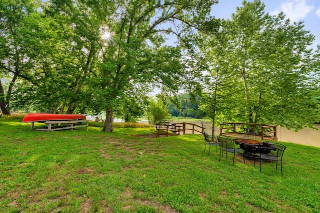 235 El Camino River Rd, Bastrop, TX 78602 - view of green lawn featuring an outdoor fire pit