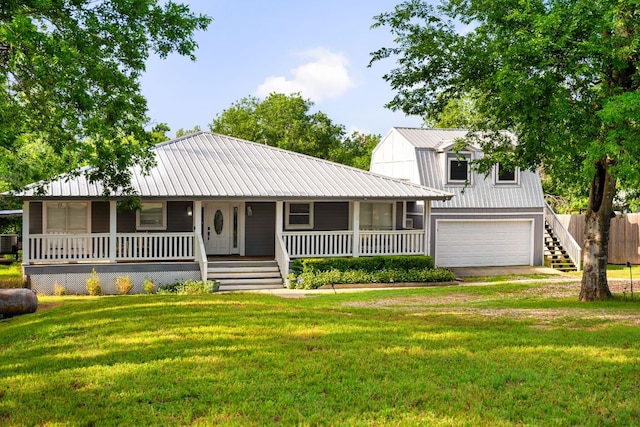 235 El Camino River Rd, Bastrop, TX 78602 - view of front of home featuring a garage, covered porch, a metal roof, and driveway