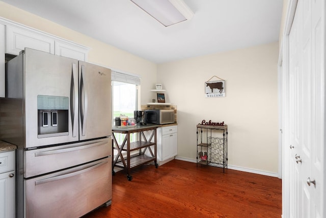235 El Camino River Rd, Bastrop, TX 78602 - kitchen featuring appliances with stainless steel finishes, dark wood-style flooring, and white cabinetry