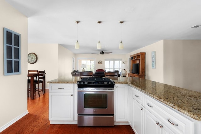 235 El Camino River Rd, Bastrop, TX 78602 - kitchen featuring stainless steel gas range oven, dark wood-style flooring, ceiling fan, light stone counters, and white cabinets