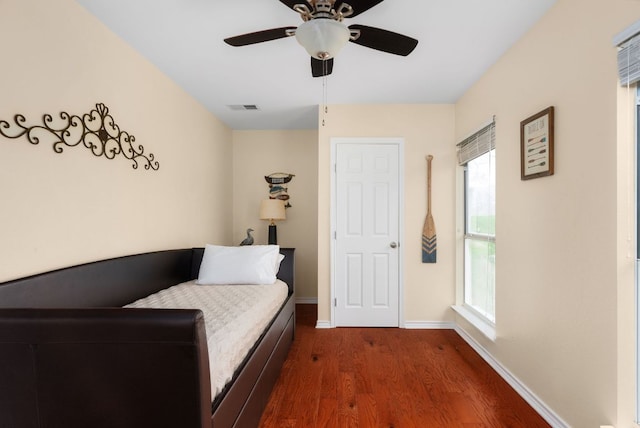 235 El Camino River Rd, Bastrop, TX 78602 - bedroom with dark wood finished floors and a ceiling fan