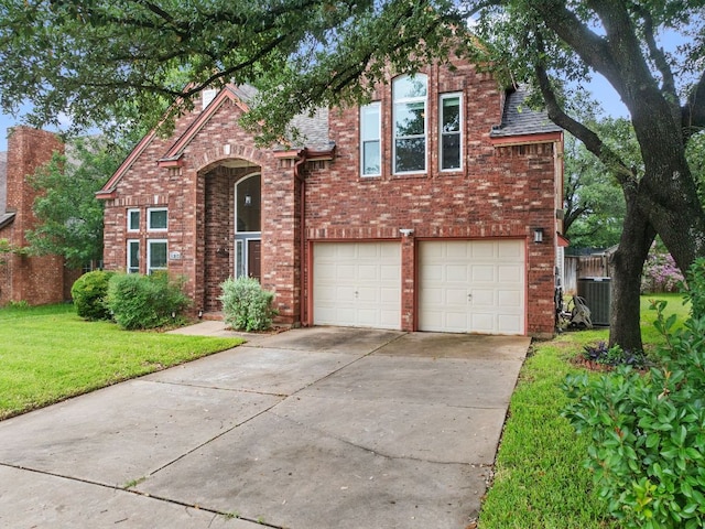 16803 Black Kettle Dr, Leander, TX 78641 - traditional home with brick siding, a garage, and driveway