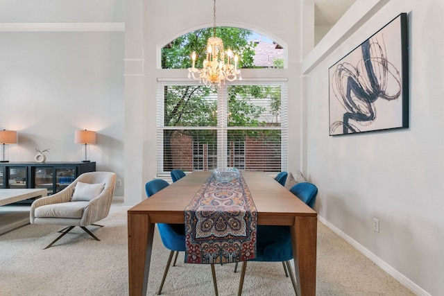 16803 Black Kettle Dr, Leander, TX 78641 - dining room with a chandelier, a high ceiling, and ornamental molding