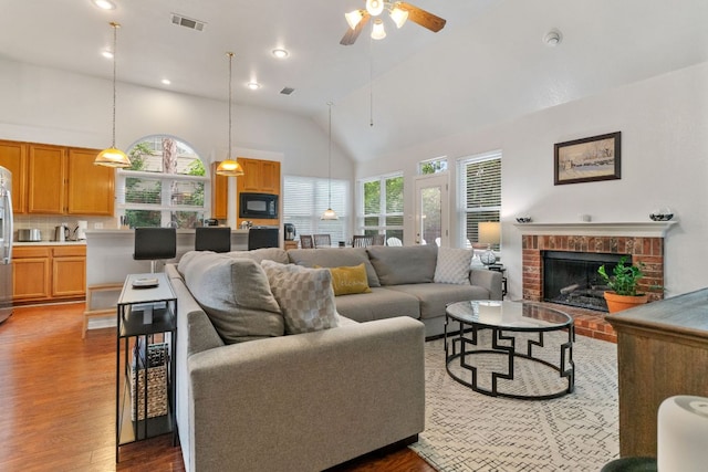 16803 Black Kettle Dr, Leander, TX 78641 - living area featuring wood finished floors, plenty of natural light, ceiling fan, a brick fireplace, and recessed lighting