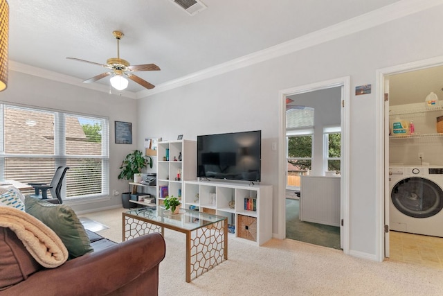 16803 Black Kettle Dr, Leander, TX 78641 - living area featuring washer / clothes dryer, ceiling fan, light colored carpet, and ornamental molding