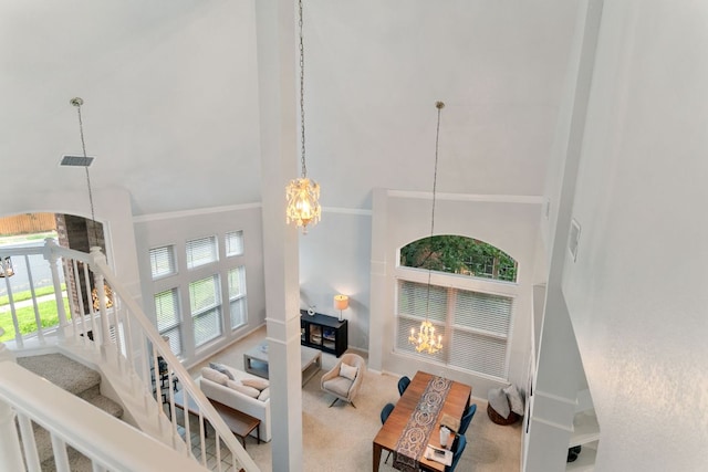 16803 Black Kettle Dr, Leander, TX 78641 - living area featuring high vaulted ceiling, a chandelier, stairs, and carpet floors