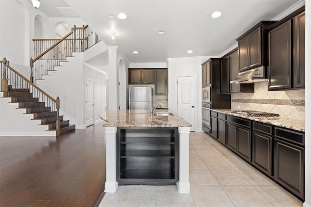 8508 Lookout Cliff Pass, Austin, TX 78737 - kitchen with appliances with stainless steel finishes, a sink, wine cooler, light stone counters, and backsplash