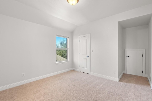 8508 Lookout Cliff Pass, Austin, TX 78737 - empty room featuring light colored carpet, lofted ceiling, and baseboards