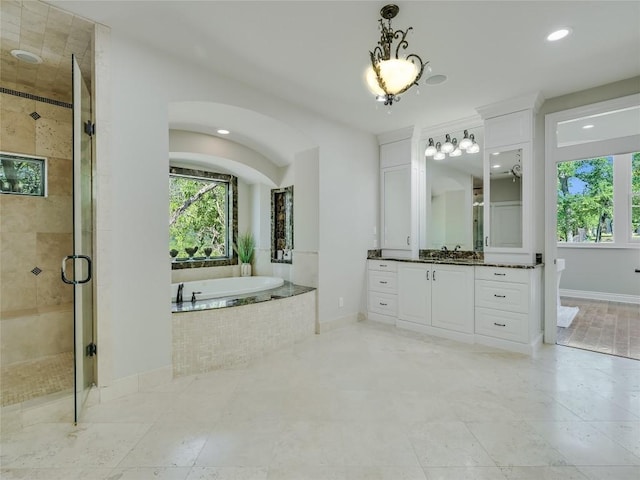 14753 Arrowhead Dr, Austin, TX 78641 - full bath featuring a garden tub, a shower stall, vanity, baseboards, and recessed lighting
