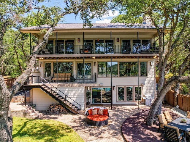 14753 Arrowhead Dr, Austin, TX 78641 - back of house with stairs, a balcony, a patio, and metal roof