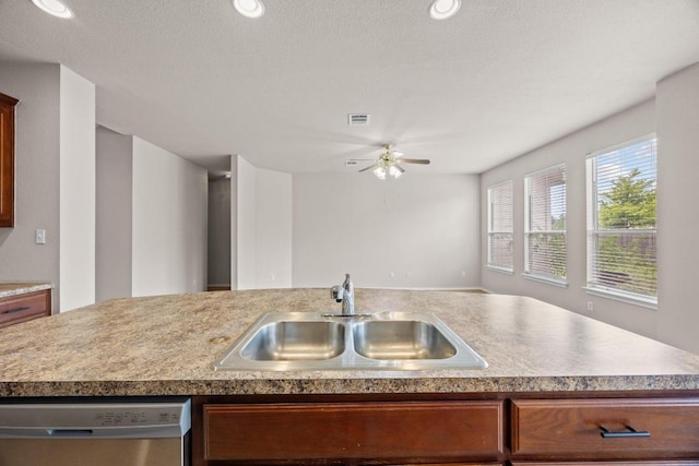 18508 Silent Water Way, Pflugerville, TX 78660 - kitchen featuring stainless steel dishwasher, a sink, a ceiling fan, light countertops, and open floor plan