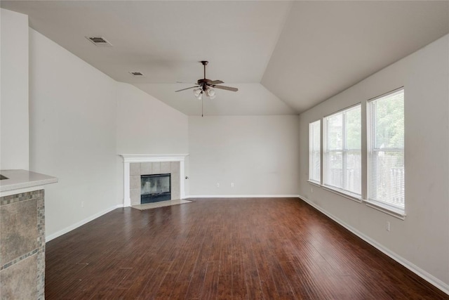 728 Stokesay Castle Path, Pflugerville, TX 78660 - unfurnished living room featuring a ceiling fan, a tile fireplace, vaulted ceiling, and dark wood-style floors