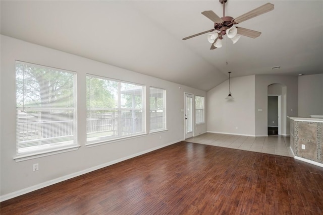 728 Stokesay Castle Path, Pflugerville, TX 78660 - unfurnished living room featuring arched walkways, light wood-type flooring, a ceiling fan, and vaulted ceiling
