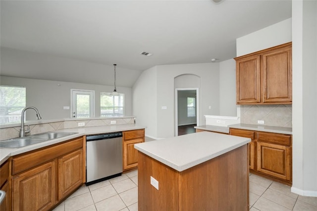 728 Stokesay Castle Path, Pflugerville, TX 78660 - kitchen with dishwasher, backsplash, brown cabinetry, and vaulted ceiling