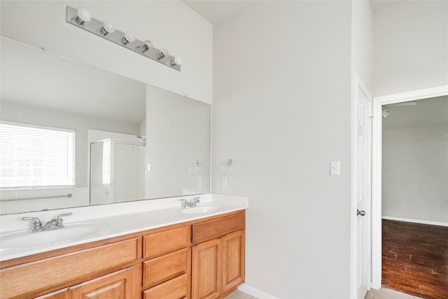 728 Stokesay Castle Path, Pflugerville, TX 78660 - full bathroom with a shower stall, double vanity, and wood finished floors