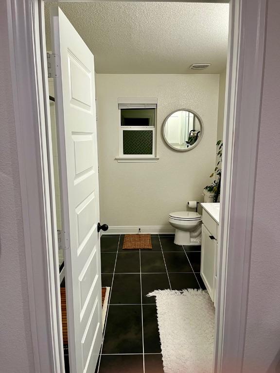 14217 Silver Lace Ln, Pflugerville, TX 78660 - bathroom with vanity, a textured ceiling, and tile patterned floors
