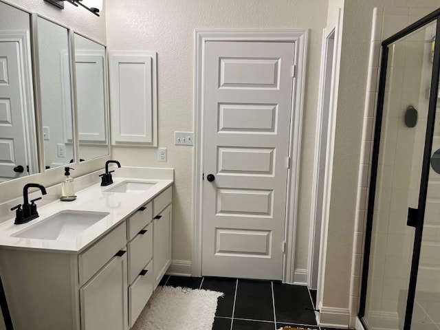 14217 Silver Lace Ln, Pflugerville, TX 78660 - bathroom featuring tile patterned flooring, double vanity, a stall shower, and a textured wall
