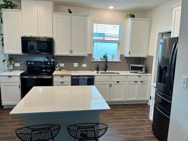 14217 Silver Lace Ln, Pflugerville, TX 78660 - kitchen with refrigerator with ice dispenser, black range with electric stovetop, wood tiled floors, dishwashing machine, and white cabinets