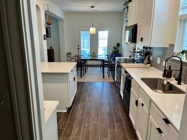 14217 Silver Lace Ln, Pflugerville, TX 78660 - kitchen featuring stainless steel microwave, white cabinets, dark wood-style flooring, and tasteful backsplash