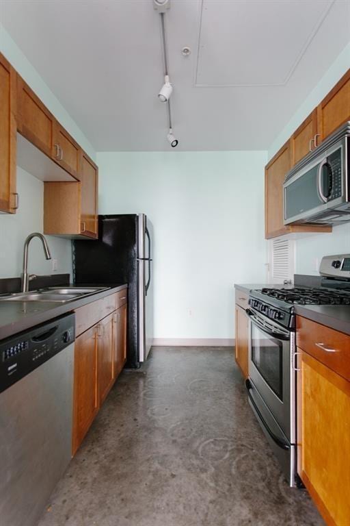 2401 E 6th St Unit 80, Austin, TX 78702 - kitchen featuring appliances with stainless steel finishes, concrete floors, a sink, brown cabinets, and dark countertops